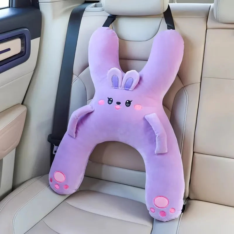 Child resting head on car travel pillow during road trip